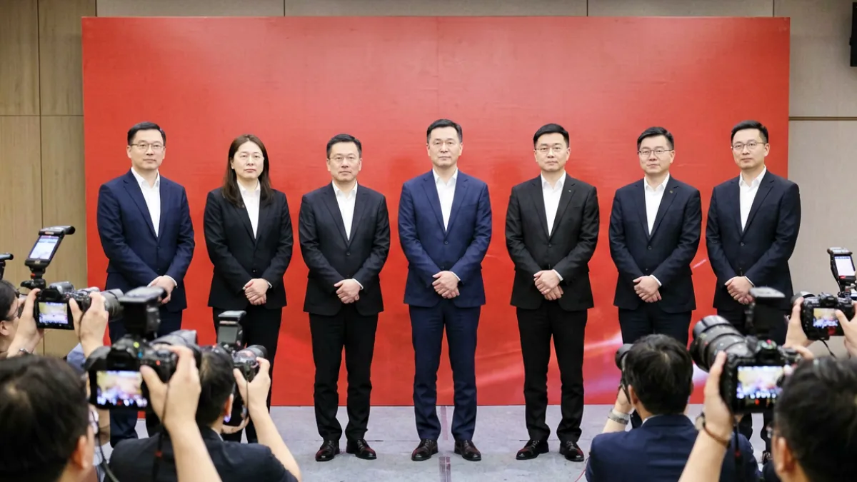 三级片新片发布会现场，主创团队站在红色幕布前接受媒体采访的场景